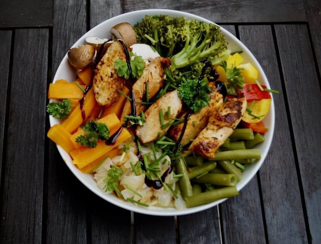 Healthy Buddha Bowl with carrots broccoli and chicken